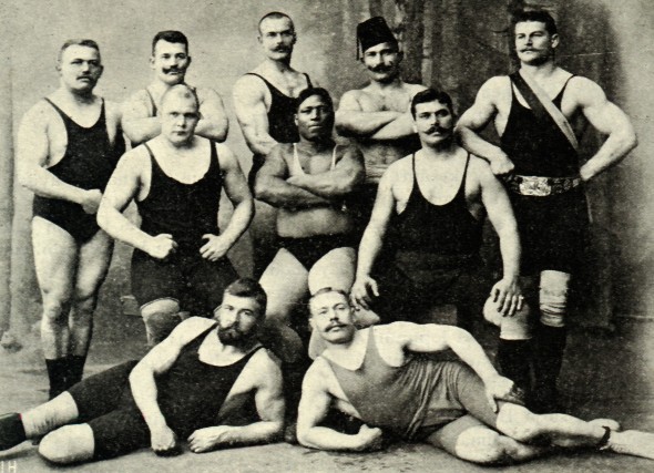Vintage weightlifters strongmen posing flexing group photo. 