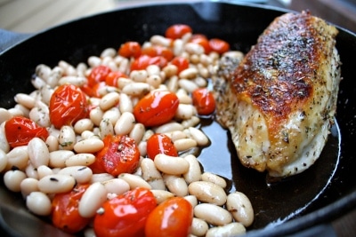 Roasted Chicken breast,tomatoes and white beans in frying pan.