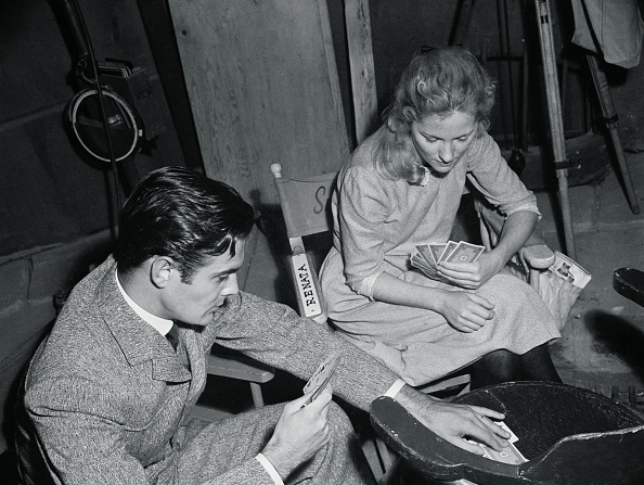 Joan Fontaine and Louis Jourdan playing cards backstage.