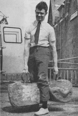 Young man in business attire lifting heavy rocks. 
