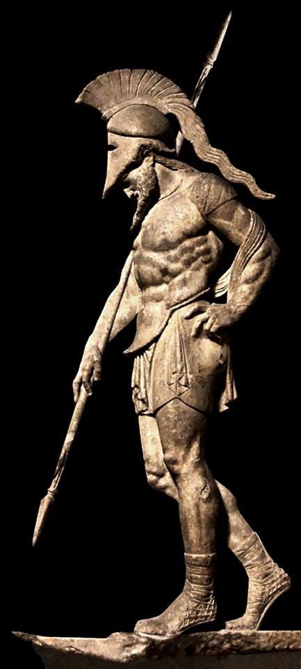 Ancient Greek warrior in metal armor statue. 